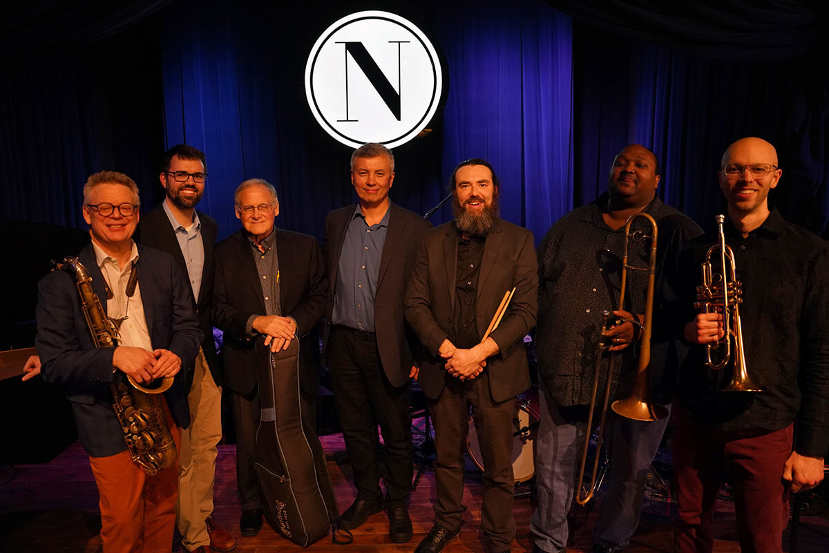 Seven people holding instruments